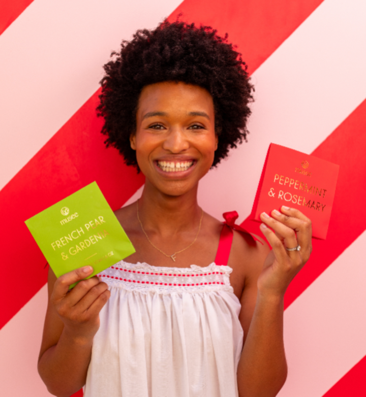 Lifestyle shot of a woman smiling while holding Musee&