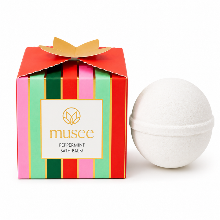 Flat image of the Musee Peppermint &amp; Rosemary Luxe Bath Balm sitting next to its box packaging. 