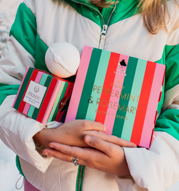 Lifestyle image of an individual holding the Musee Peppermint &amp; Rosemary Luxe Bath Balm and the Peppermint &amp; Rosemary Shower Steamers in her arms.
