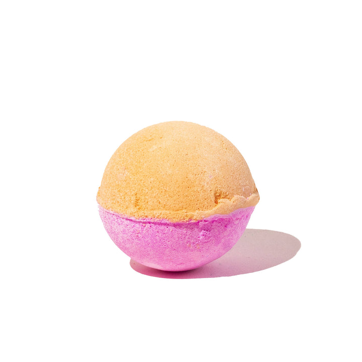 Musee Tiny Dancer surprise bath balm unwrapped, showing its vibrant orange and pink coloring. 