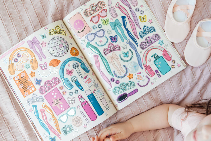 Child exploring reusable dance accessory stickers including tiaras, ribbons and headphones