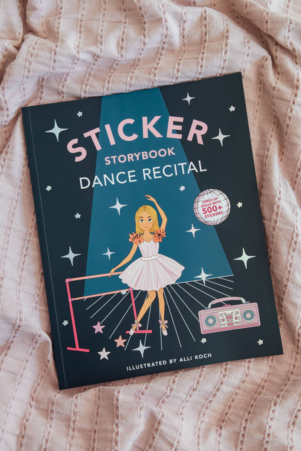 My Sticker Storybook Dance Recital activity book displayed on a pink textured blanket