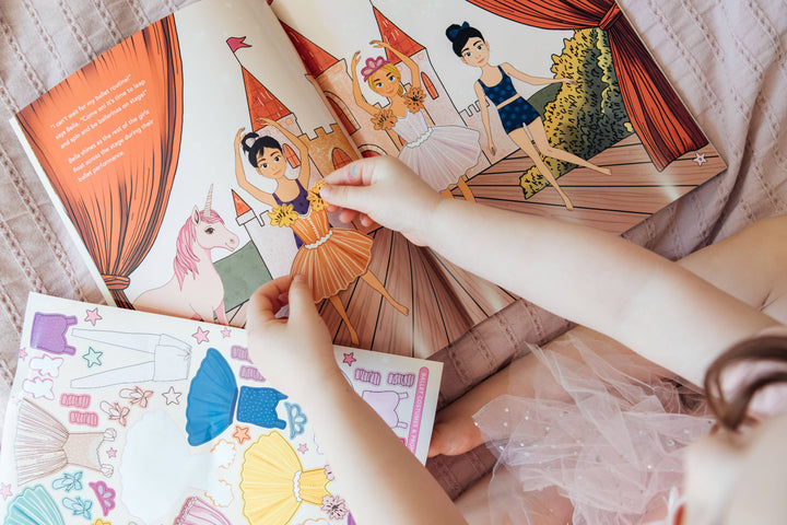 Child using a ballerina sticker in the My Sticker Storybook Dance Recital activity book