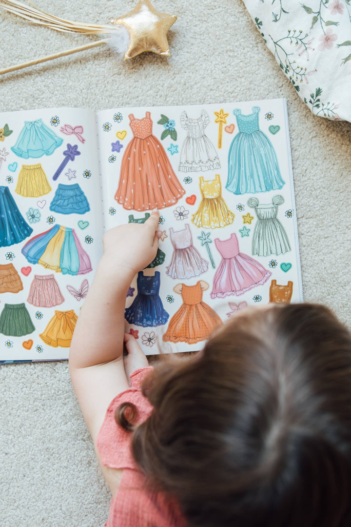 Child exploring colorful dress stickers in My Sticker Storybook Fairies and Unicorns
