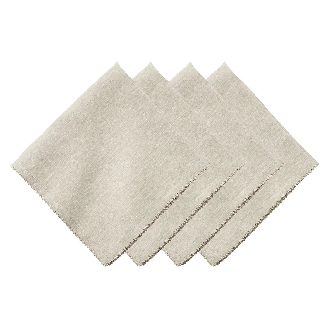 Set of four natural linen napkins featuring a delicate neutral crochet trim around the edges