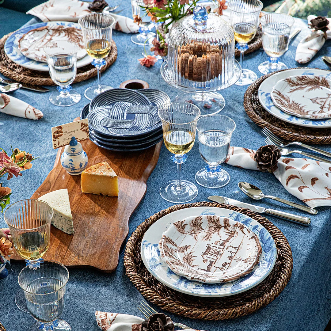 Nell Ruffle Chambray petite cake dome and stand displayed with coordinating blue dinnerware and serving pieces