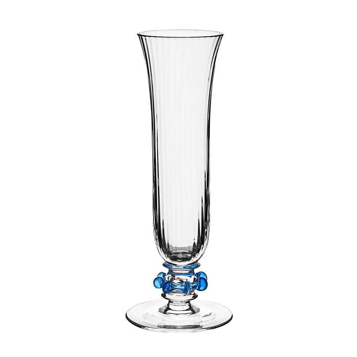 Nell Ruffle Flute in Chambray featuring clear ribbed glass, a flared rim, and decorative blue glass ruffle accents around the stem.
