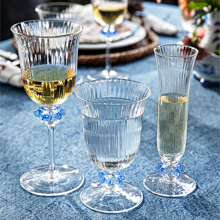 Nell Ruffle Flute in Chambray styled with coordinating blue-accented glassware on an elegant dining table.