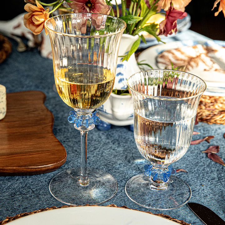 Nell Ruffle Wine Glass in Chambray styled for entertaining with clear textured glass and distinctive chambray blue ruffle accents.