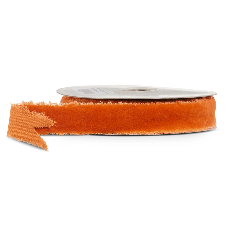 Orange ribbon with frayed edges on a roll, featuring a rich burnt orange color and soft texture for Christmas wreaths, garlands, bows, and holiday decorating.