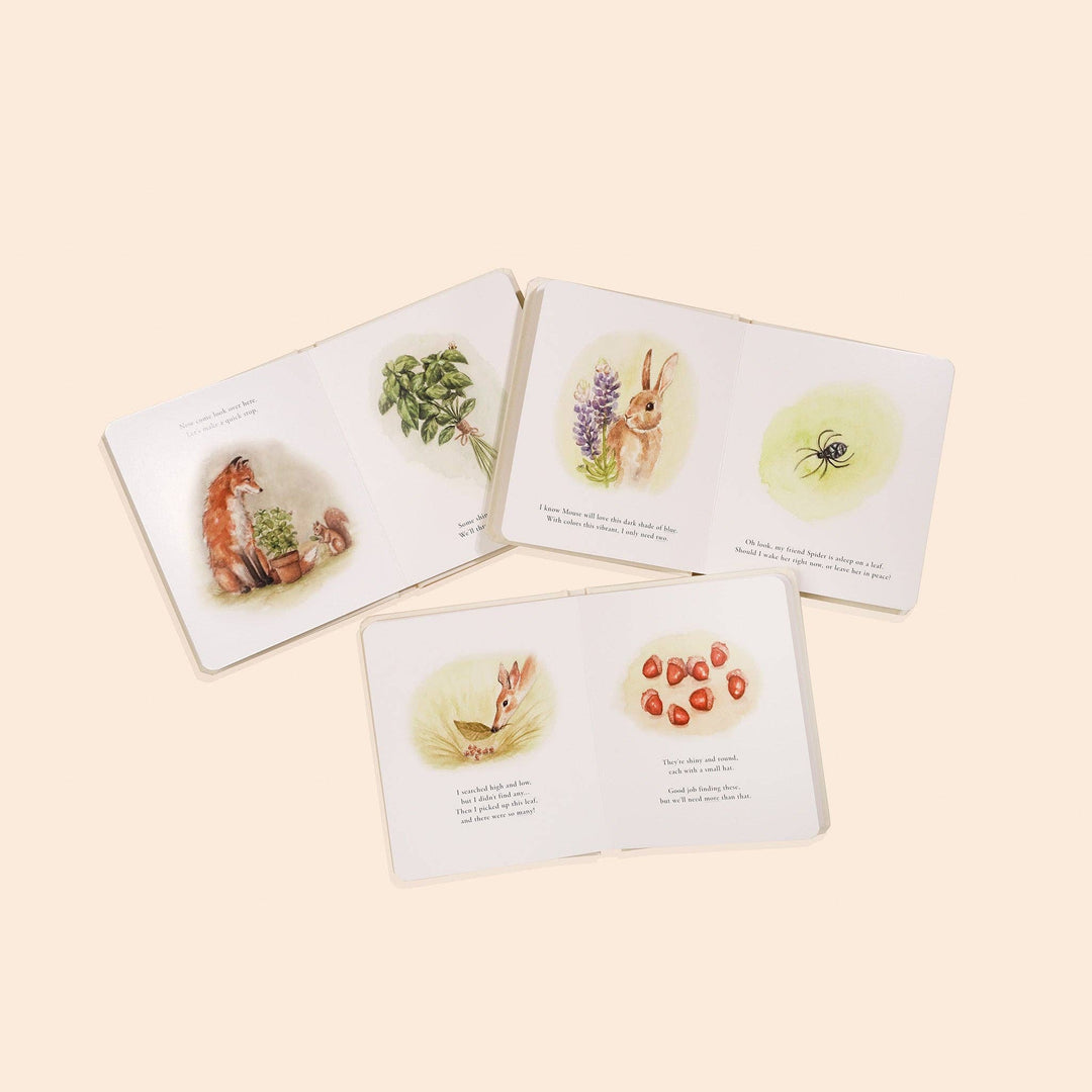 Three Our Little Adventures board books open to watercolor story pages featuring fox, rabbit, spider and berries