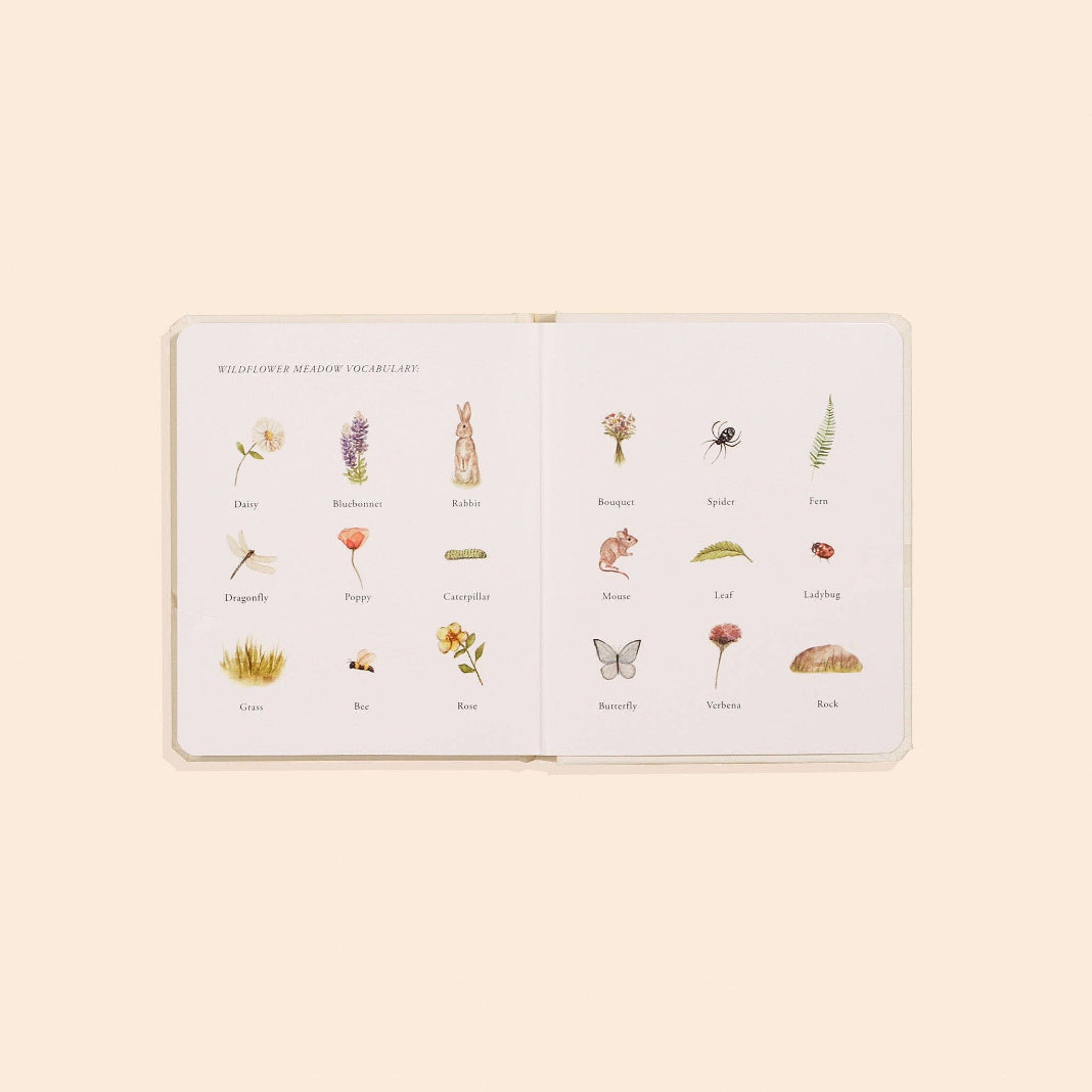 Our Little Adventures Wildflower Meadow board book open to illustrated vocabulary pages with flowers, animals and insects