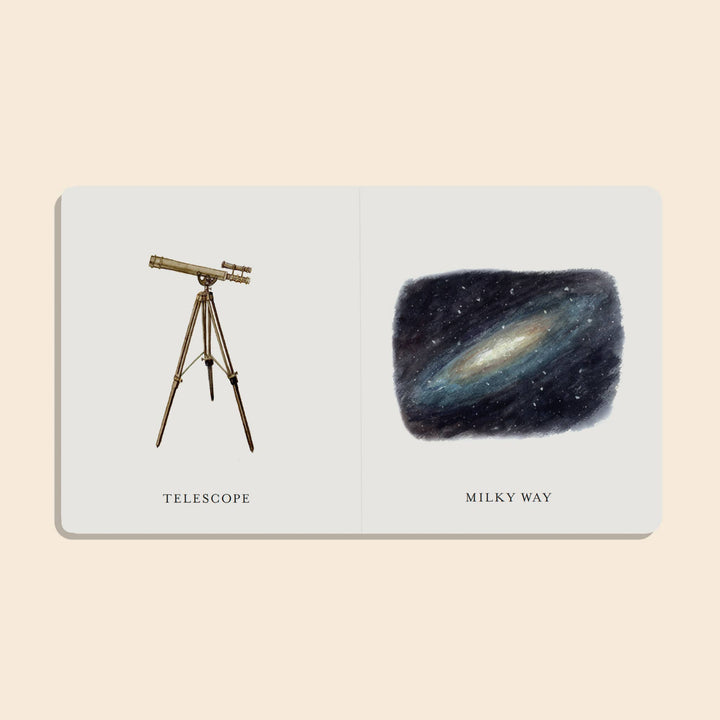 Our Little Library Vol. 3 Space board book open to illustrated Telescope and Milky Way vocabulary pages
