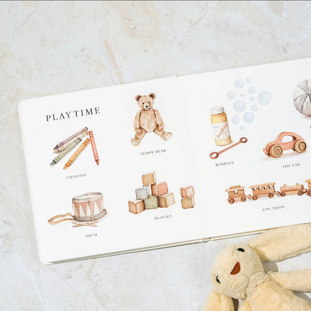 Interior Paige Tate & Co.'s Our Big Book of words featuring illustrations of items that deal with playtime.
