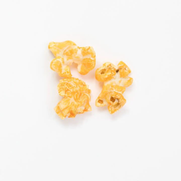 Close-up of cheesy Pimento Cheese Hand-Crafted Popcorn pieces