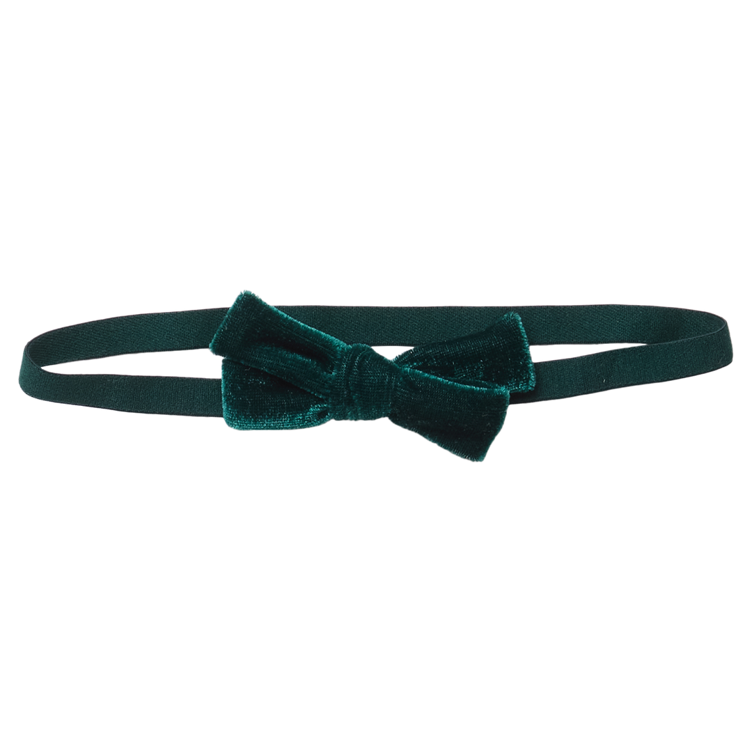 Flat image of Pink Chicken's Baby Bow Stretchy Headband In Hunter Green Velour with no background. 