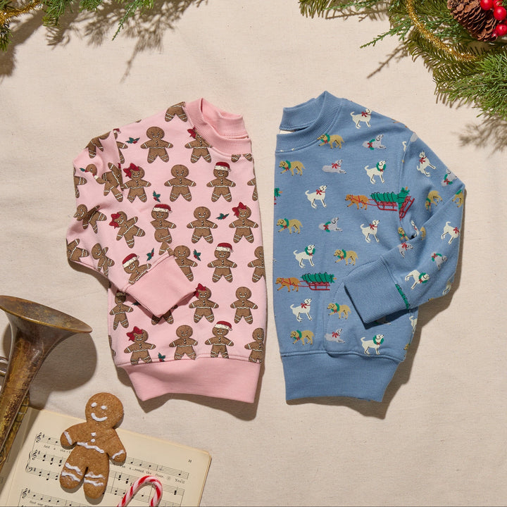Pink Gingerbread Cookie Play Sweatshirt displayed beside blue Holiday Labs sweatshirt in festive flat lay