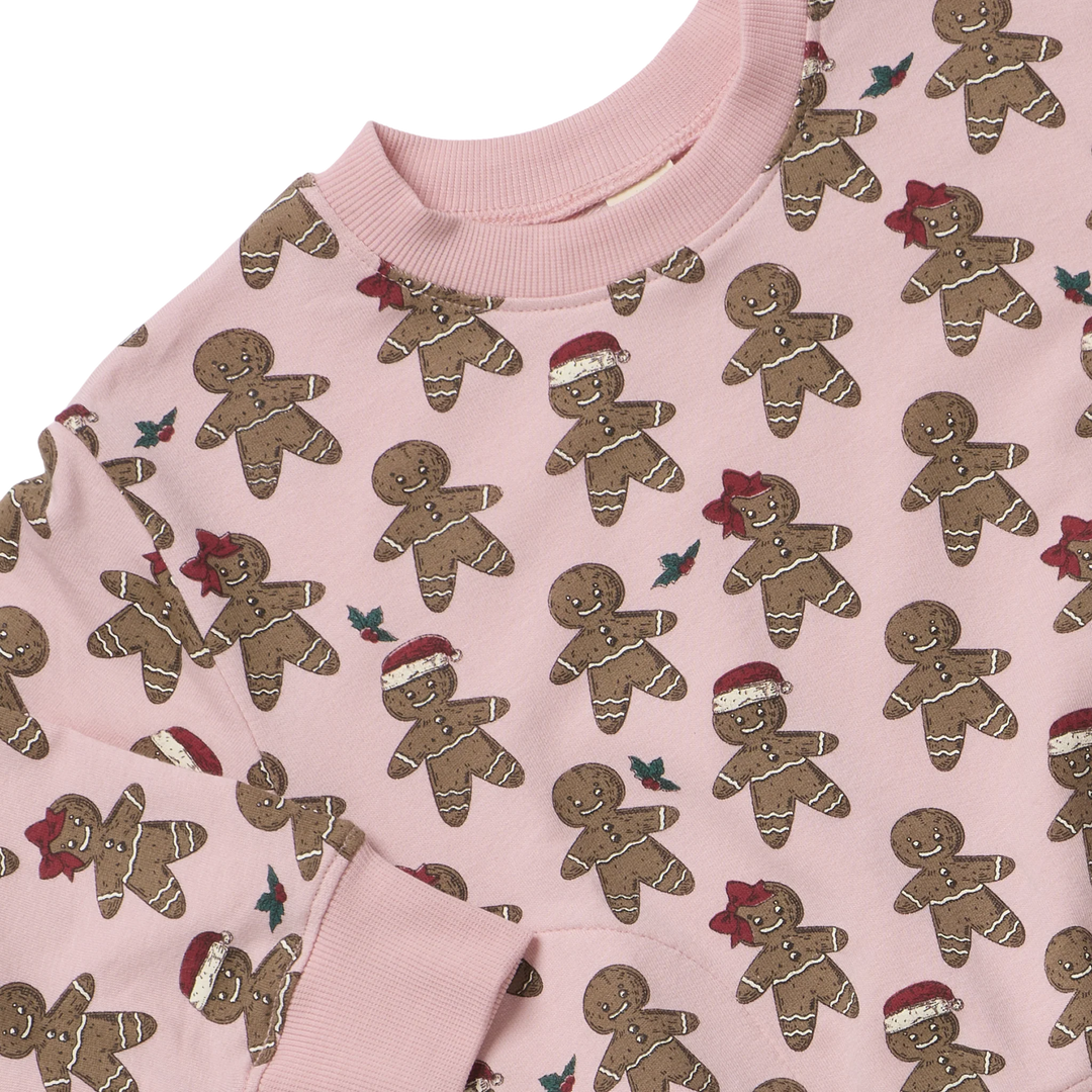 Close-up of pink Gingerbread Cookie Play Sweatshirt showing holiday gingerbread print and ribbed neckline