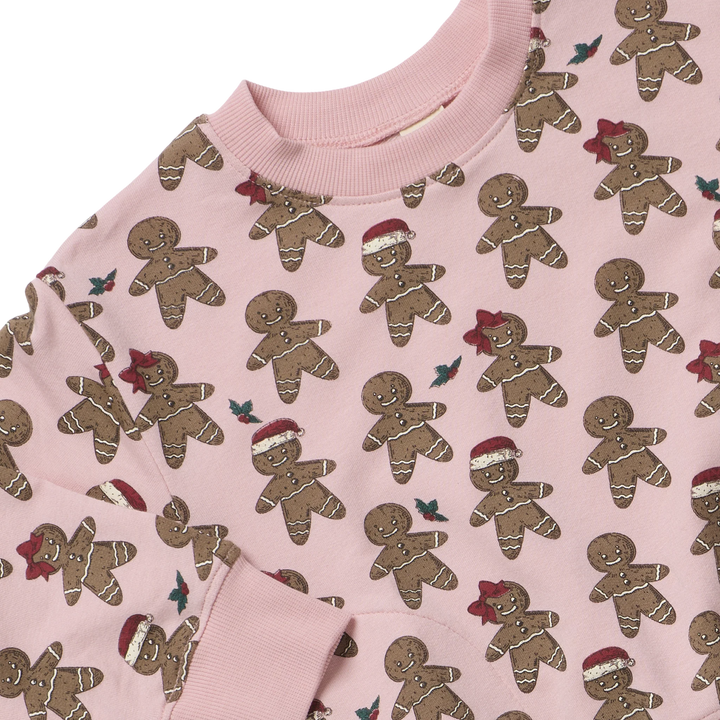 Close-up of pink Gingerbread Cookie Play Sweatshirt showing holiday gingerbread print and ribbed neckline