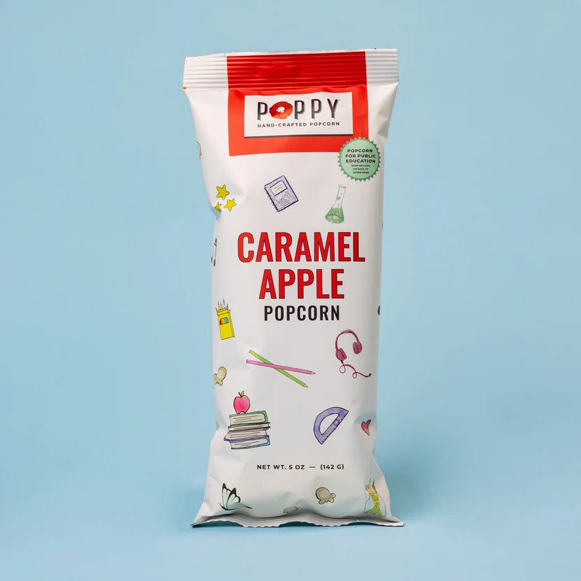 Poppy Caramel Apple Hand-Crafted Popcorn in a white and red 5 oz snack bag with colorful school-themed illustrations.