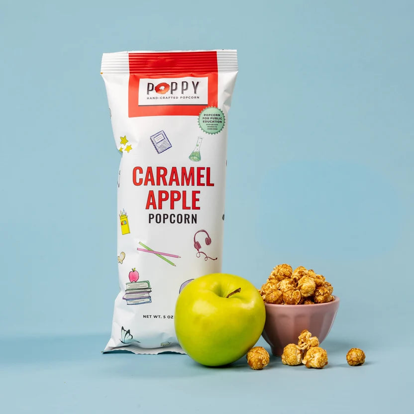 Poppy Caramel Apple Popcorn displayed with a fresh green apple and a bowl of golden caramel-coated popcorn.