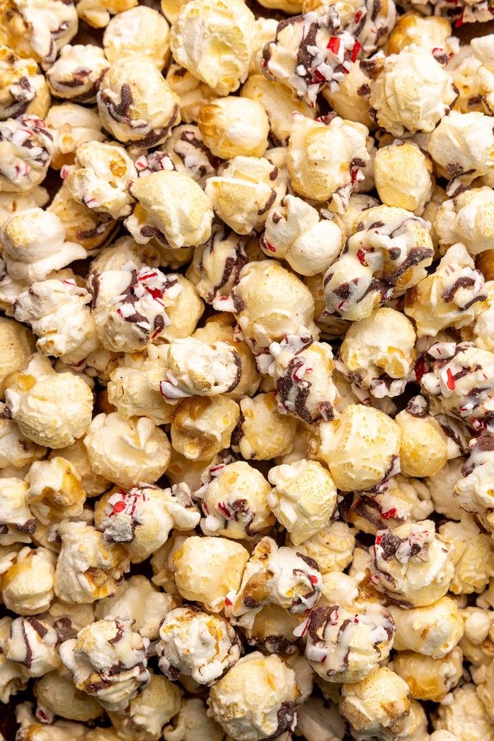 Gourmet popcorn drizzled with white and dark chocolate and crushed peppermint
