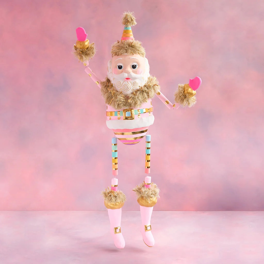 Rainbow Papa Noel Christmas display with white skin, a pastel striped suit, gold accents, pink boots, and raised arms against a soft pink holiday backdrop.
