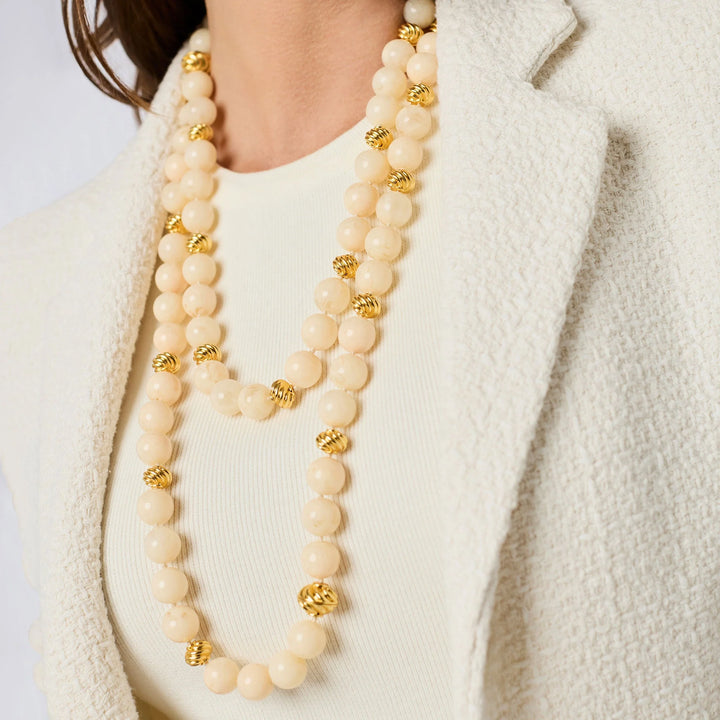 Model wearing the ivory Ravello 5-in-1 Necklace styled as layered long strands