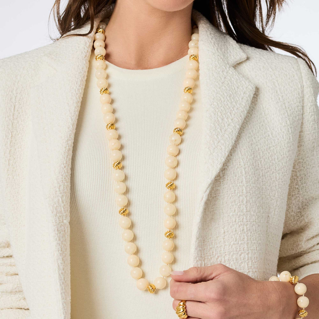 Model wearing the ivory Ravello 5-in-1 Necklace styled as a single long strand