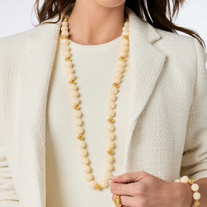 Model wearing the ivory Ravello 5-in-1 Necklace styled as a single long strand