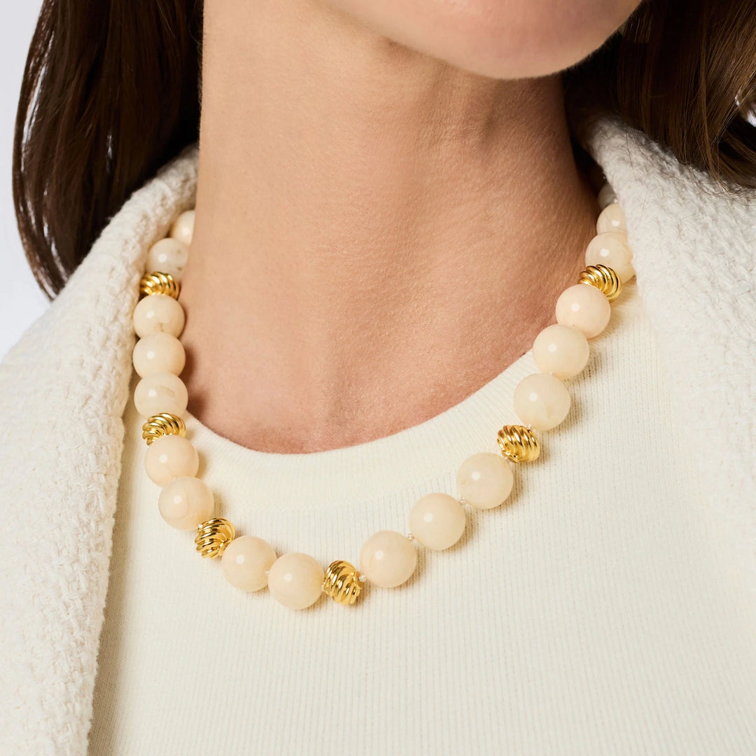 Model wearing the Ravello 5-in-1 Necklace in ivory styled as a short necklace