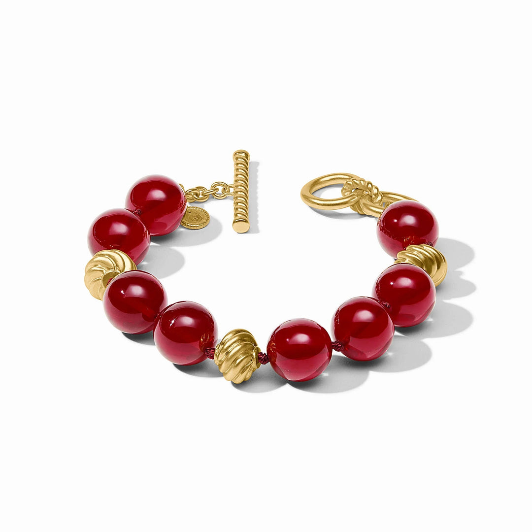 Ravello Bracelet in cranberry red with glossy round cabochons, sculpted gold accents, and toggle closure
