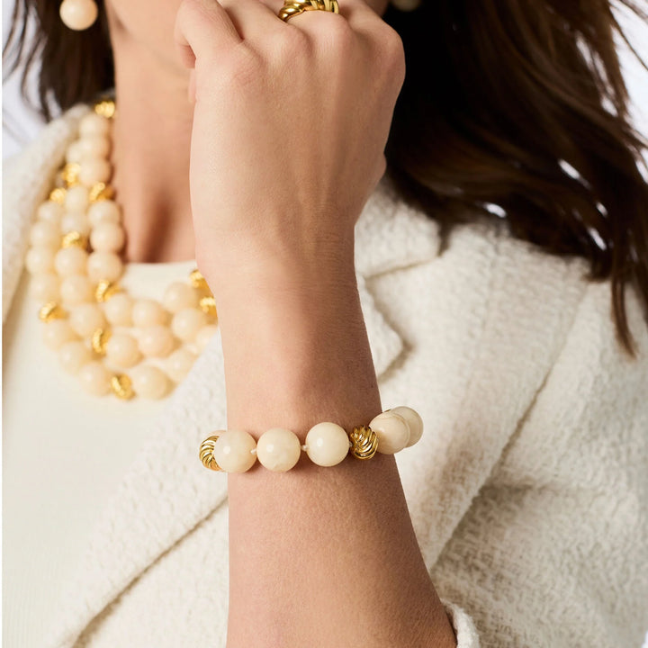 Model wearing the Ravello Bracelet in ivory with round cabochons and gold accents