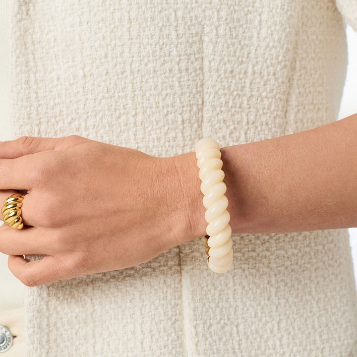 Model wearing the Ravello Statement Bangle in ivory with sculpted twisted detailing