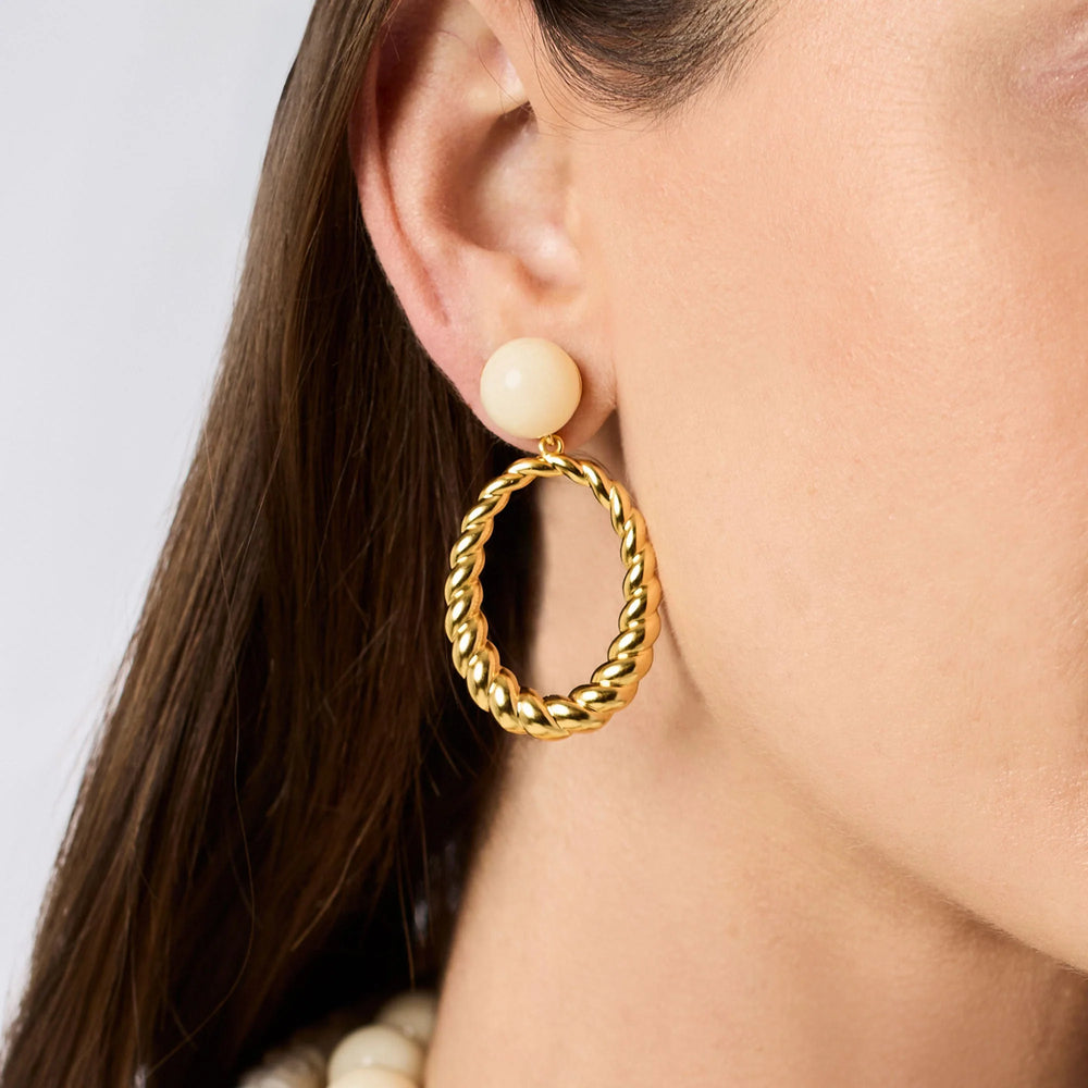 Model wearing Ravello Statement Earrings with ivory cabochon studs and gold twisted rope drops