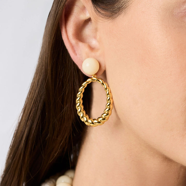 Model wearing Ravello Statement Earrings with ivory cabochon studs and gold twisted rope drops