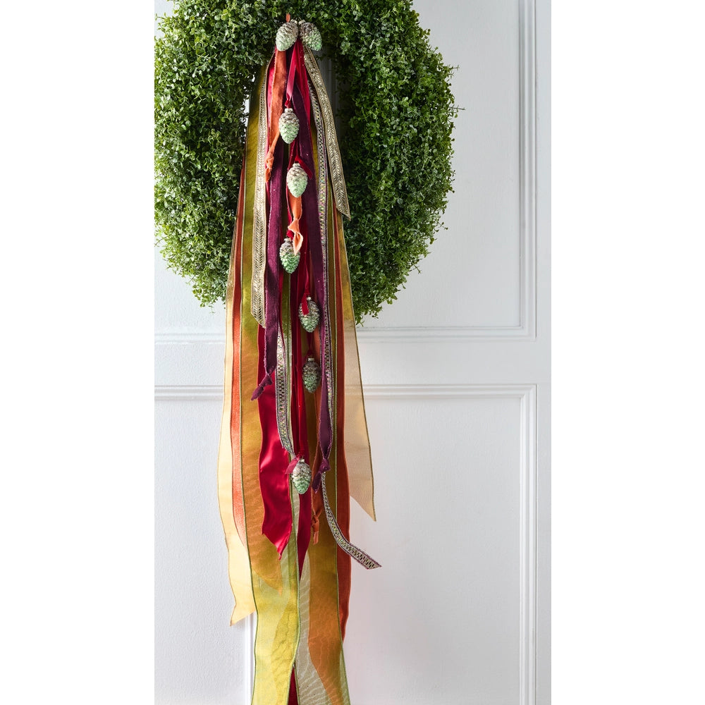 Gold jeweled wired ribbon featuring vibrant colors and sparkling accents, beautifully displayed on a wreath. Perfect for adding shimmer and festive color to Christmas wreaths, holiday décor, celebrations, gift wrapping, garlands, bows, and special event decorations.