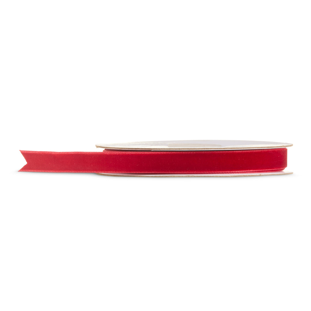 Red velvet ribbon on a roll featuring a rich classic red finish for Christmas trees, wreaths, garlands, holiday bows, gift wrapping, and festive Christmas decorating.