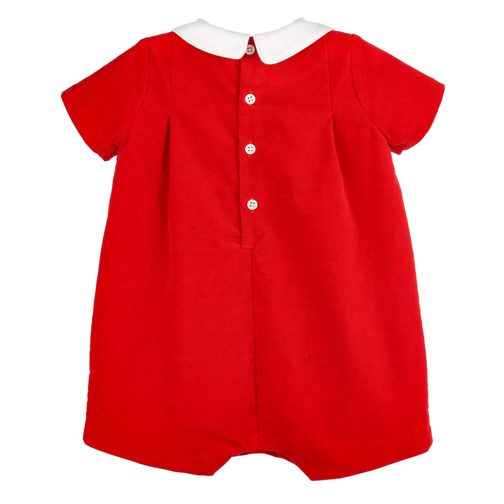 Back view of red velvet Christmas romper with white split collar, short sleeves, and button-back closure.