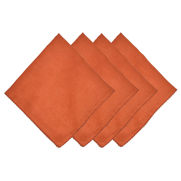 Set of four rust terracotta linen dinner napkins with decorative stitched edging
