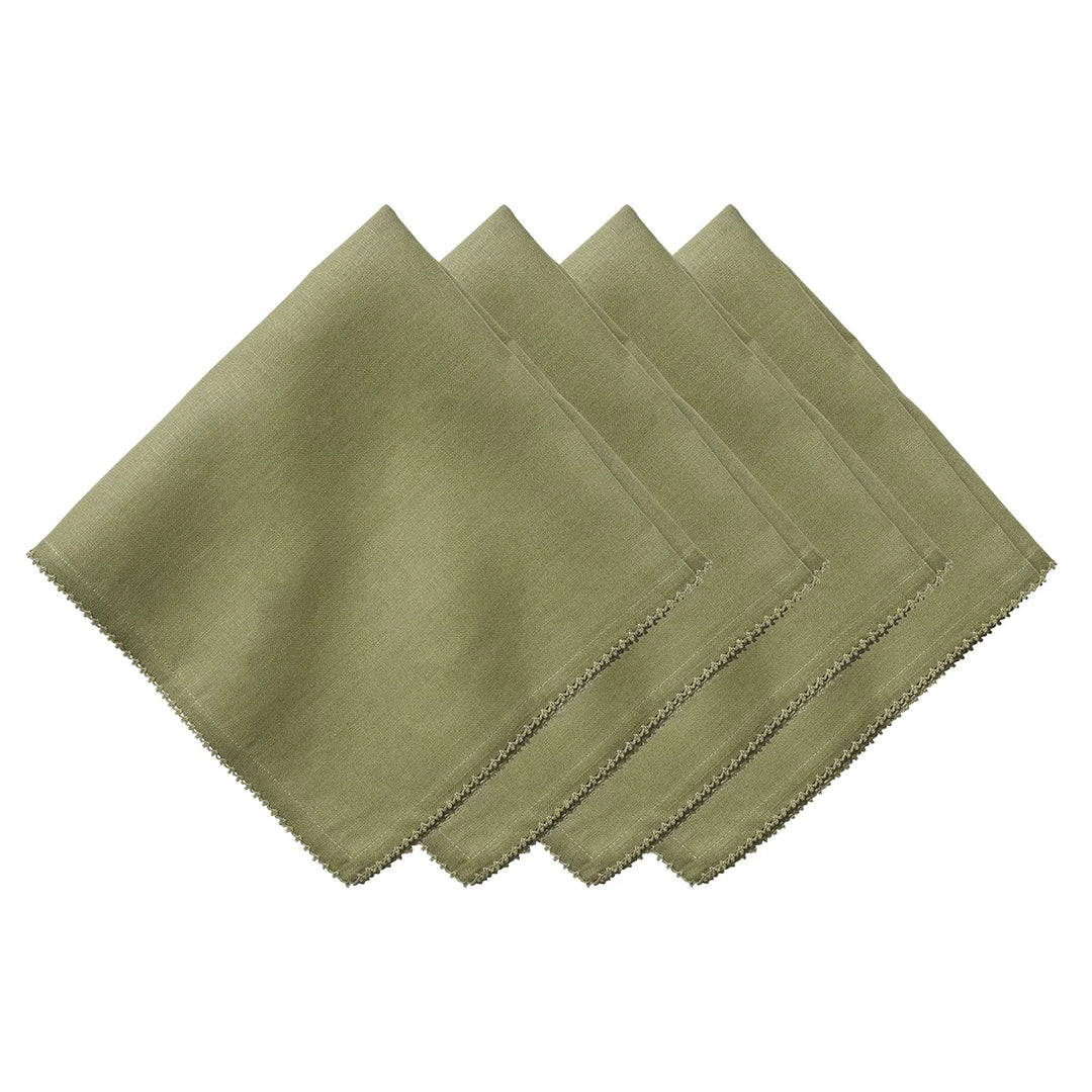 Set of four sage green linen napkins featuring delicate tonal crochet edging for an elegant table setting