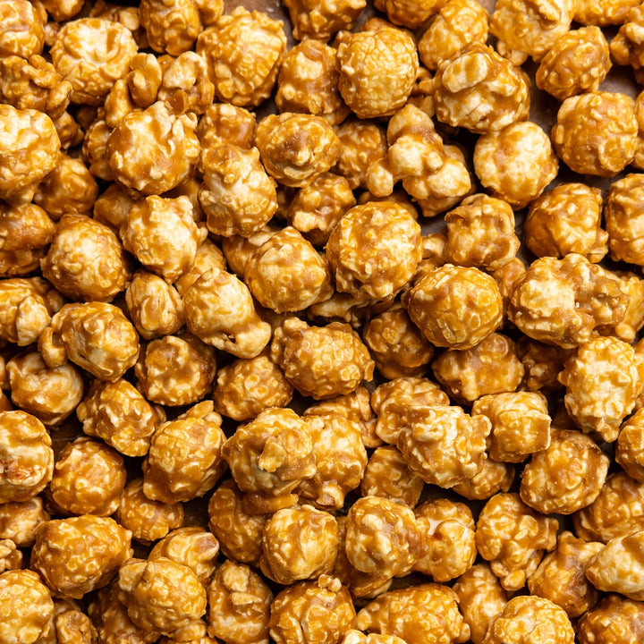 Close-up of crunchy Salted Caramel Hand-Crafted Popcorn coated in golden caramel