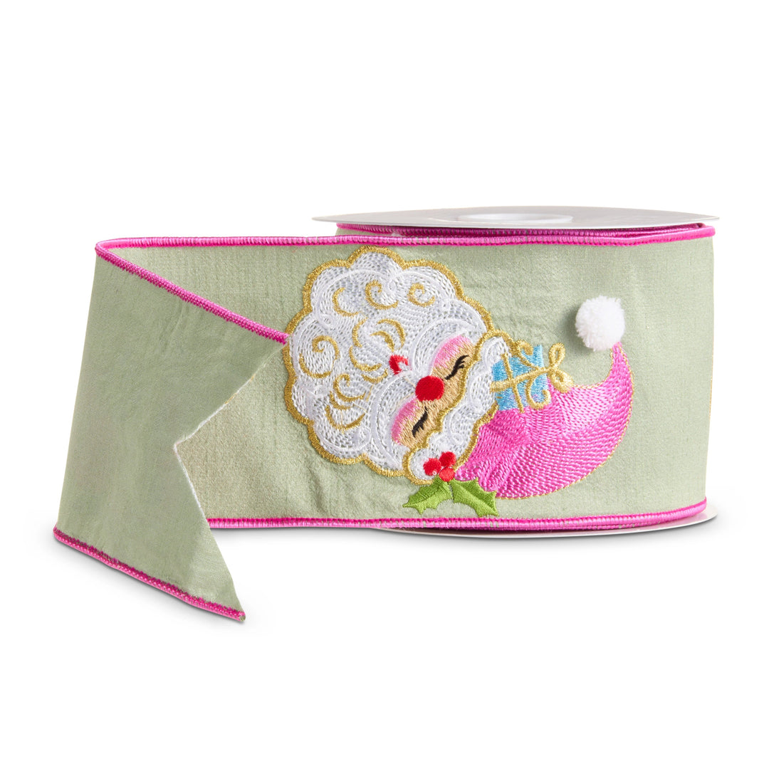 Light sage green wired Christmas ribbon featuring an embroidered Santa holding a bright pink and blue gift, finished with hot pink wired edges and festive holly accents.