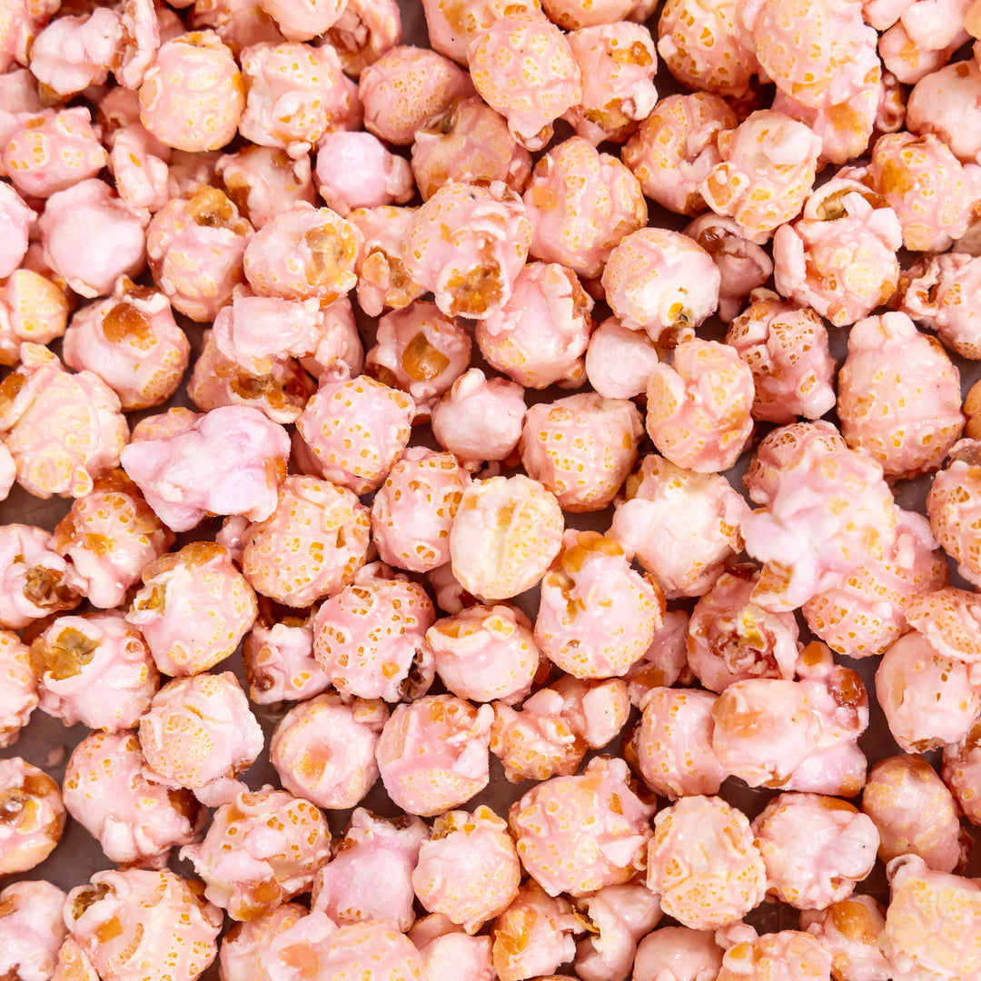 Close-up of pink Shirley Temple popcorn with sweet cherry and citrus-inspired flavor