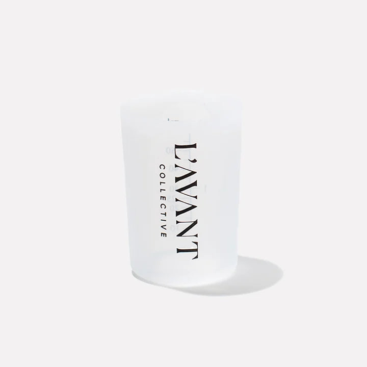 Front view of a translucent silicone laundry detergent measuring cup featuring the L&
