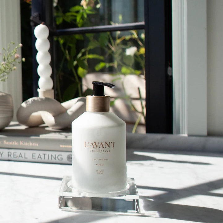 Small clear lucite tray holding a hand lotion dispenser on a countertop, ideal for organizing soap, lotion, or other bathroom essentials.