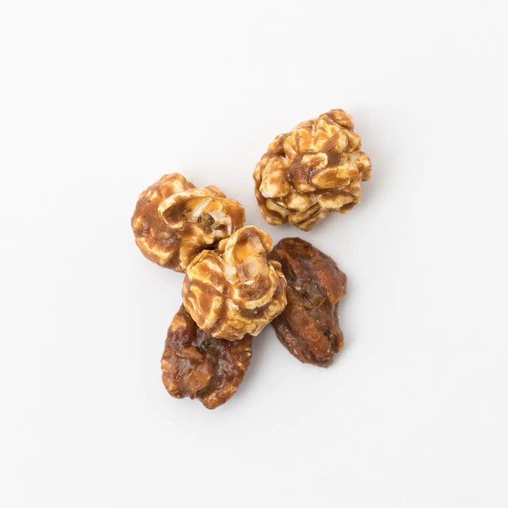 Close-up of caramel-coated Southern Pecan Pie popcorn with whole pecans