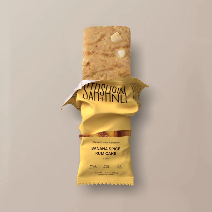 Stars + Honey Banana Spice Rum Cake collagen protein bar shown inside open wrapper