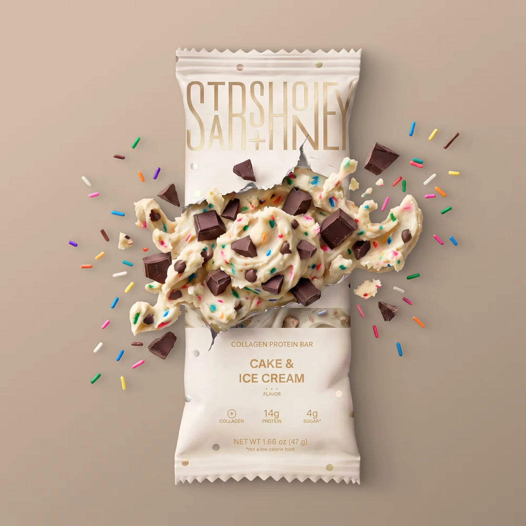Stars + Honey Cake &amp; Ice Cream collagen protein bar with cake pieces, chocolate chunks, and rainbow sprinkles
