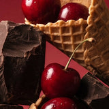 Close-up of Stars + Honey Cherry Chocolate Waffle Cone collagen protein bar with cherry, chocolate and waffle cone pieces